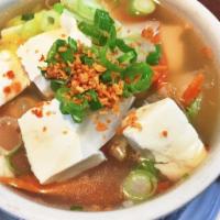 Tofu Soup · Tofu in a clear broth with carrot, napa, green onion, and cilantro.