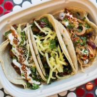 3 Tacos · Soft corn tortillas, includes choice of slaw & toppings.