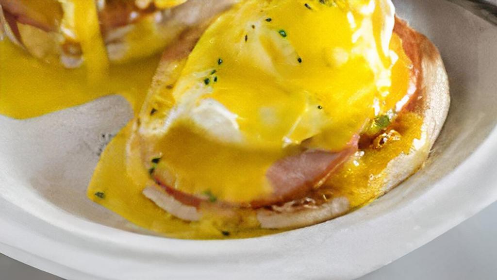 Eggs Benedict · Two poached eggs, ham, on an english muffin covered in hollandaise sauce.