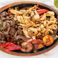 Fajitas · Our fajitas are grilled with onions and bell peppers. Served with lettuce, sour cream,  pico...
