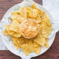 Buffalo Chicken Dip · Mix of Chicken, cheeses and our homemade hot sauce served with tortilla chips