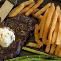 Ribeye · 12 oz grilled ribeye topped with garlic butter. Served with your choice of two sides.