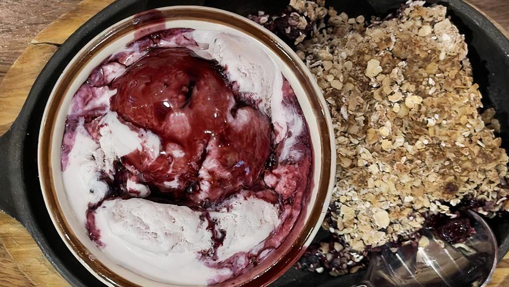 Berry Crumble · Fresh baked, hot crumbles with raspberries, blueberries, and blackberries. Served with berry ice cream and a bourbon berry drizzle.