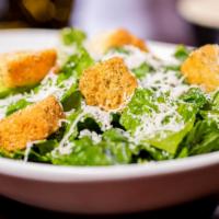 Caesar Salad · Romaine hearts with homemade croutons, romano cheese, and caesar dressing