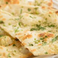 Plain Naan · Unleavened white flour bread baked in our tandoor.