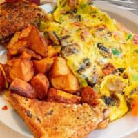 Everything Omelette · Onions, peppers, tomatoes, mushrooms, bacon, ham a sausage and american cheese
