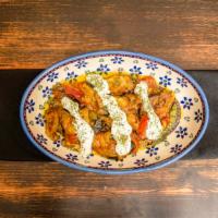 Borani Banjan · Fried eggplant seasoned with an afghan style sofrito. Topped with our homemade garlic mint y...
