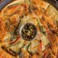 Scallion Pancake · Traditional Korean scallion pancake with red bell pepper and scallion shoots served with a s...