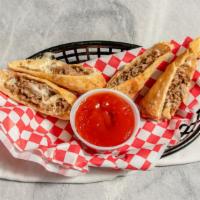 Cheesesteak Egg Rolls (2) · Served with whiz and spicy ketchup.