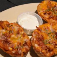 Bacon And Cheese Potato Skins · Stuffed Potato Skins loaded with Bacon and Monterey Jack Cheese, served with a side of Sour ...