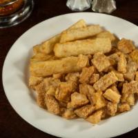 Torresmo Com Mandioca · Crispy and melt-in-your-mouth fried pork belly served with Oliveira's fried yucca.