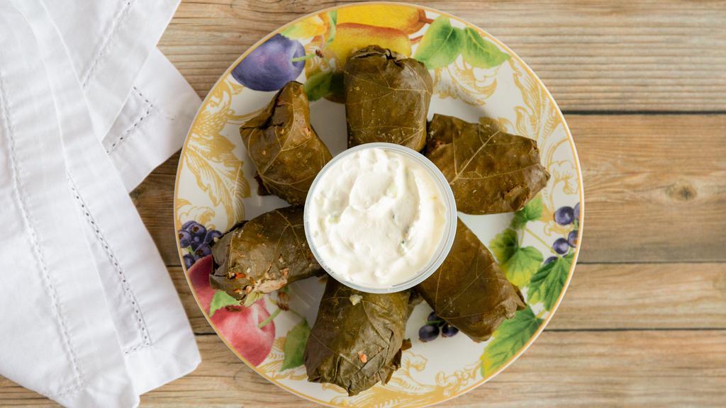 Dolmades (6) · Grape leaves stuffed with rice and beef mixture.