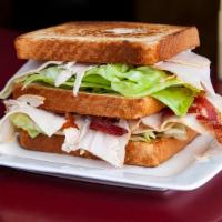 Turkey Club Sandwich · On white or wheat bread, American cheese, bacon, lettuce, tomato and mayonnaise.