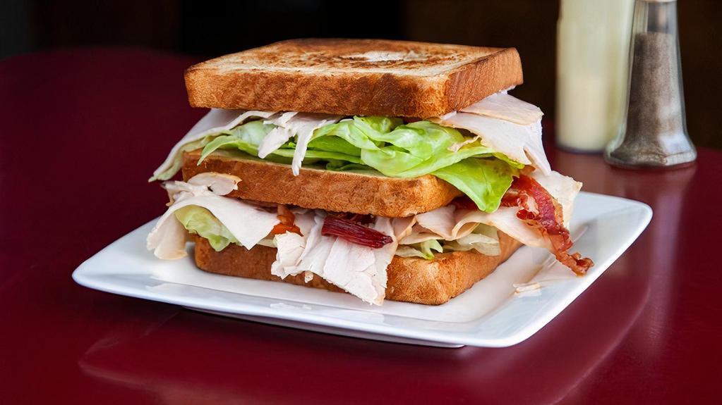 Turkey Club Sandwich · On white or wheat bread, American cheese, bacon, lettuce, tomato and mayonnaise.