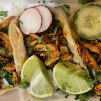 Chicken Tacos Traditionales · Three soft corn tortillas, meat, served with cilantro, onions & limes.