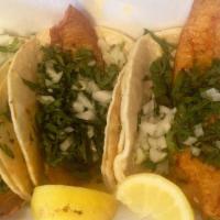 Fish Tacos Traditionales · Three soft corn tortillas, meat, served with cilantro, onions & limes.