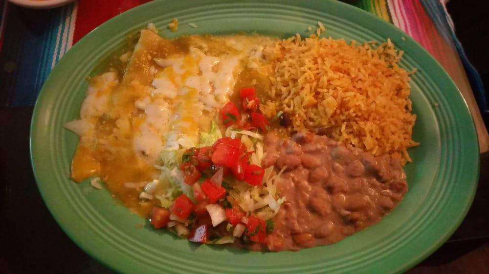 Mole Enchiladas Platter · Three soft corn tortillas filled with chicken and topped with mole sauce, fresh cheese, onions, rice and beans.