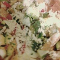 Nachos Texanos · Tortilla chips with cheese, jalapeno, tomato, onion, and sour cream.