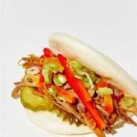 Lil Bao Wow · roast pork belly, green chili sauce, radish, pickles. ​