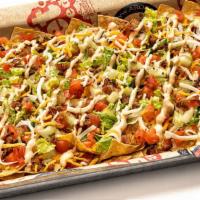 Bacon Cheeseburger Nachos · Flash-fried tortilla chips layered with bacon cheeseburger dip and topped with melted cheese...