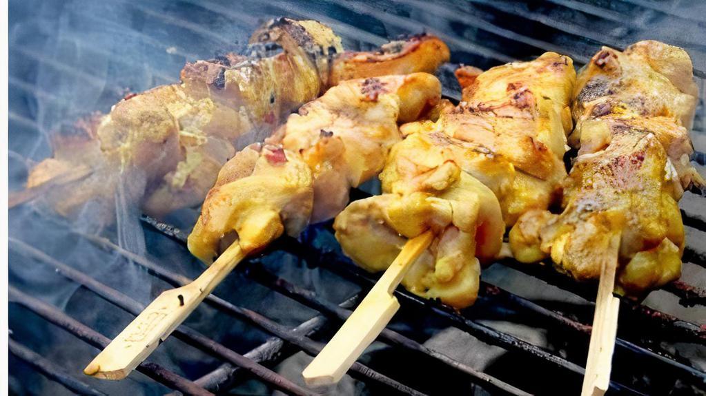 Chicken Satay · Grilled chicken on skewer marinated in coconut base spices served with cucumber salad and Thai peanut sauce.