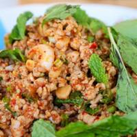 Larb Gai · New. Spicy. Ground chicken in chili lime juice with red onion, mint, roasted rice, scallion,...
