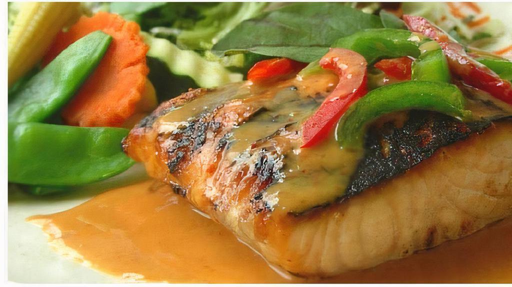 Salmon Red Sea · Spicy. Gluten-free. Grilled salmon fillet in red curry, bell peppers, shredded lime leaves served with mixed vegetables.