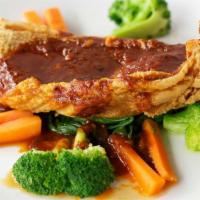 Crispy Red Snapper · Filet of red snapper with sweet and spicy curry or tamarind sauce with a side of vegetables.