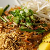 Pad Thai · Contains egg. With bean sprouts, peanuts, carrots, chives, and garnished with mango, served ...