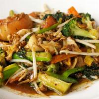 Pad See Ew · Stir-fry thick rice noodles with Chinese broccoli, carrots, tomatoes, and bean sprouts serve...