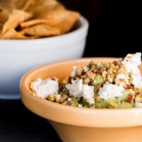 Toasted Pistachio Guacamole · Goat cheese and red pepper flakes.