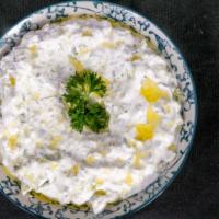 Tzatziki · Greek yogurt with fresh chopped cucumbers, mint, garlic and olive oil. Served with pita bread.