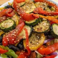 Grilled Veggie Salad · Grilled Zucchini, yellow squash and roasted red peppers served on a bed of crisp  romaine le...