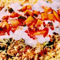 Chicken Biryani · Flavored basmati rice cooked with special spices and topped with golden fried onions and mint.
