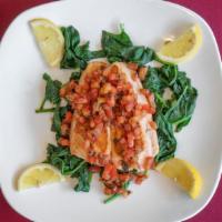Grilled Salmon · Fresh salmon filet topped with bruschetta tomatoes served with sautéed spinach.