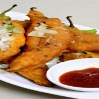 Mirchi Pakoda · Long hot peppers, sliced and filled with mildly spiced potato mixture. Lightly coated and de...