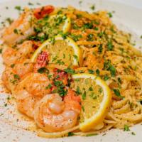 Shrimp Scampi · Jumbo gulf shrimp, cooked with white wine, lemon, garlic and butter, served over linguine.