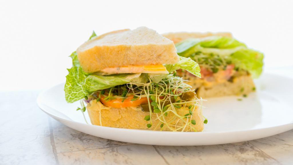 Dirk'S Spicy Veggie · Homemade hummus, swiss & cheddar cheese, jalapenos, red onions, romaine lettuce, sprouts (temporarily out), tomato, topped with our homemade chipotle spread, salt & pepper.