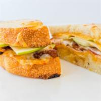Spicy Apple Bacon Grilled Cheese · Melted cheddar and provolone cheese, thick-sliced apples, bacon, and pepper jelly.