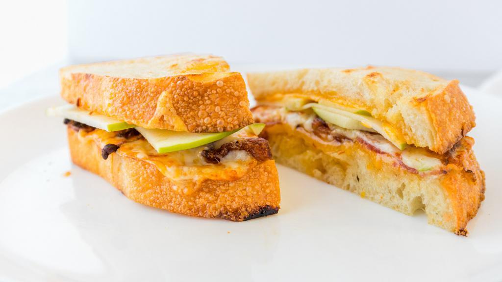 Spicy Apple Bacon Grilled Cheese · Melted cheddar and provolone cheese, thick-sliced apples, bacon, and pepper jelly.