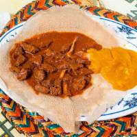 Zigene (Key Wat) · Lean round beef cuts stewed in this berbere spiced tomato-onion based stew. Spicy.