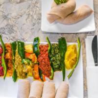 Ethiopian Veggie Combo · Lentils, yellow split peas, green lentils, cabbag spinach, beets, potatoes, and ethiopian to...