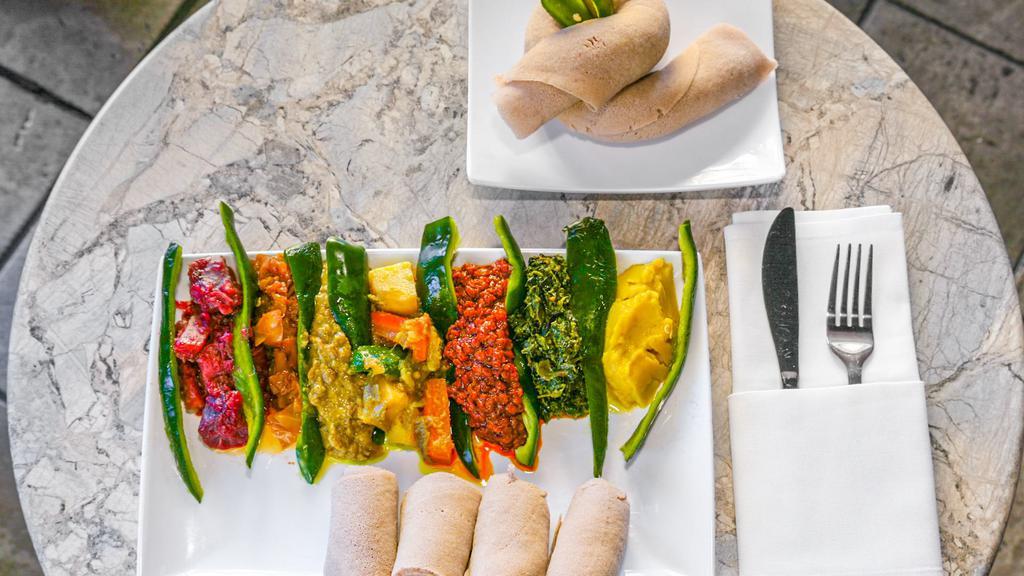 Ethiopian Veggie Combo · Lentils, yellow split peas, green lentils, cabbag spinach, beets, potatoes, and ethiopian tomato salad.