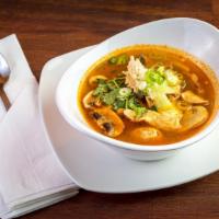 Tom Yum · Popular Thai soup cooked in Thai herbs with chili, lime, kaffir leaves, lemongrass and mushr...