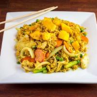 Mango Fried Rice · Fried rice with mango, carrots, peas, scallions, chicken and shrimp cooked in yellow curry p...