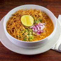 Khao Soi · Northern creamy curry-based soup served with egg noodles and ground chicken topped with cris...