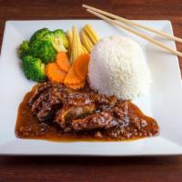 Tamarind Duck · Crispy duck topped with our house tamarind sauce and fried red onions with steamed broccoli,...