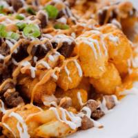 Kimchi Supreme Tots · Seasoned tater tots baked with a cheddar or mozzarella cheese mix and topped with grilled ki...