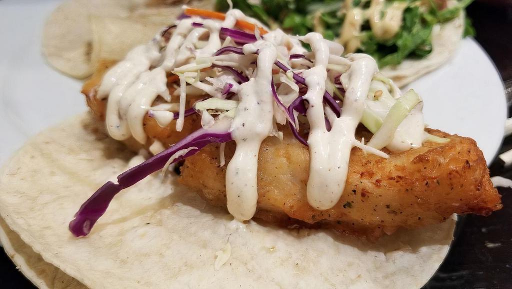 Fried Fish · Beer battered cod topped with cabbage, pico de gallo and our house baja sauce.