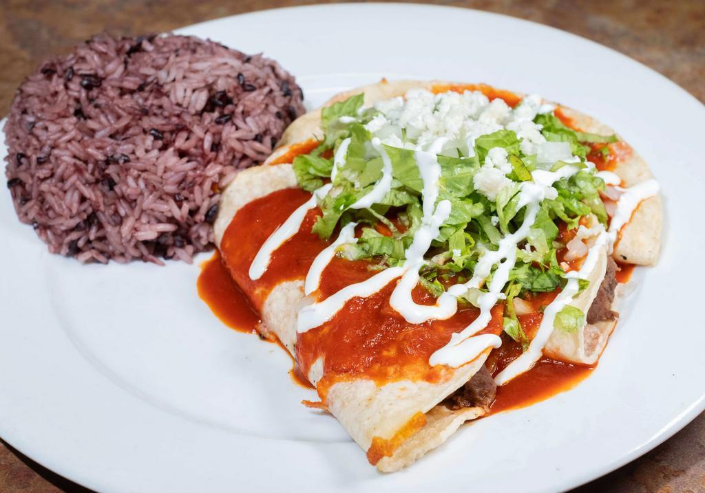 Enchiladas · Melted cheese in a corn tortilla with your choice of meat topped with guakillo enchilada sauce, lettuce, onions, sour cream, and fresco cheese.
